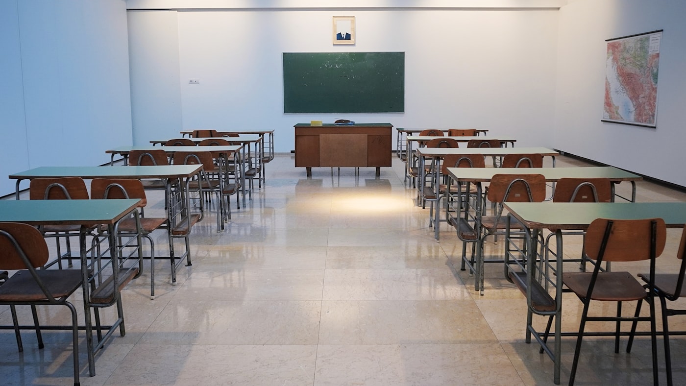 Bright, clean NYC classroom with desks and chairs
